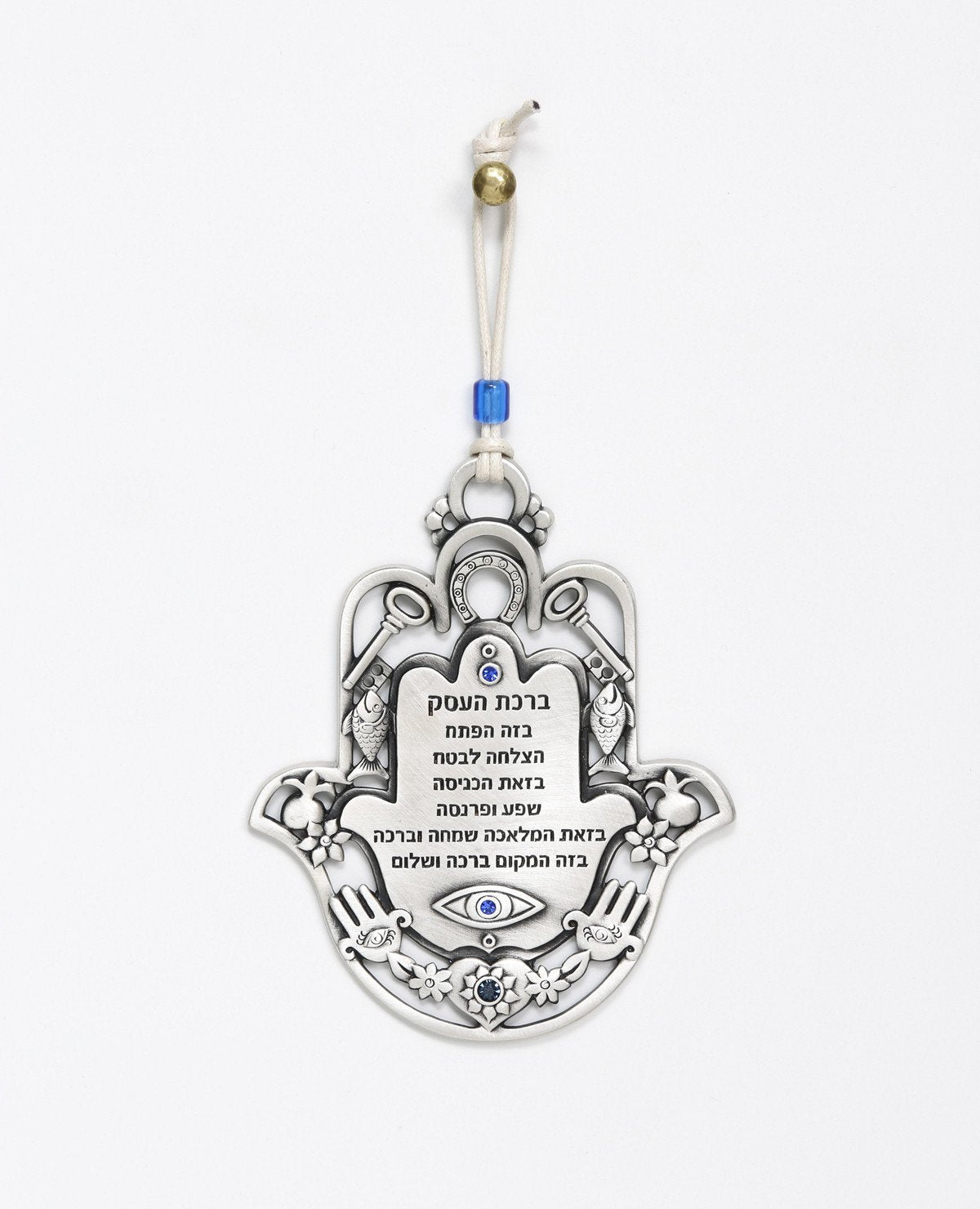 An impressive and richly designed Business Blessing Hamsa for hanging, coated in sterling silver and embedded with blue Swarovski crystals. The Hamsa comes as a frame and is decorated with motifs of luck, abundance and a blessing for the business with a plate at the center featuring blessings of wealth and livelihood. At the bottom of the plate is an engraved eye embedded with a blue crystal, to protect against the "evil eye". A wonderful and exciting gift for anyone with a new or existing business. The orn