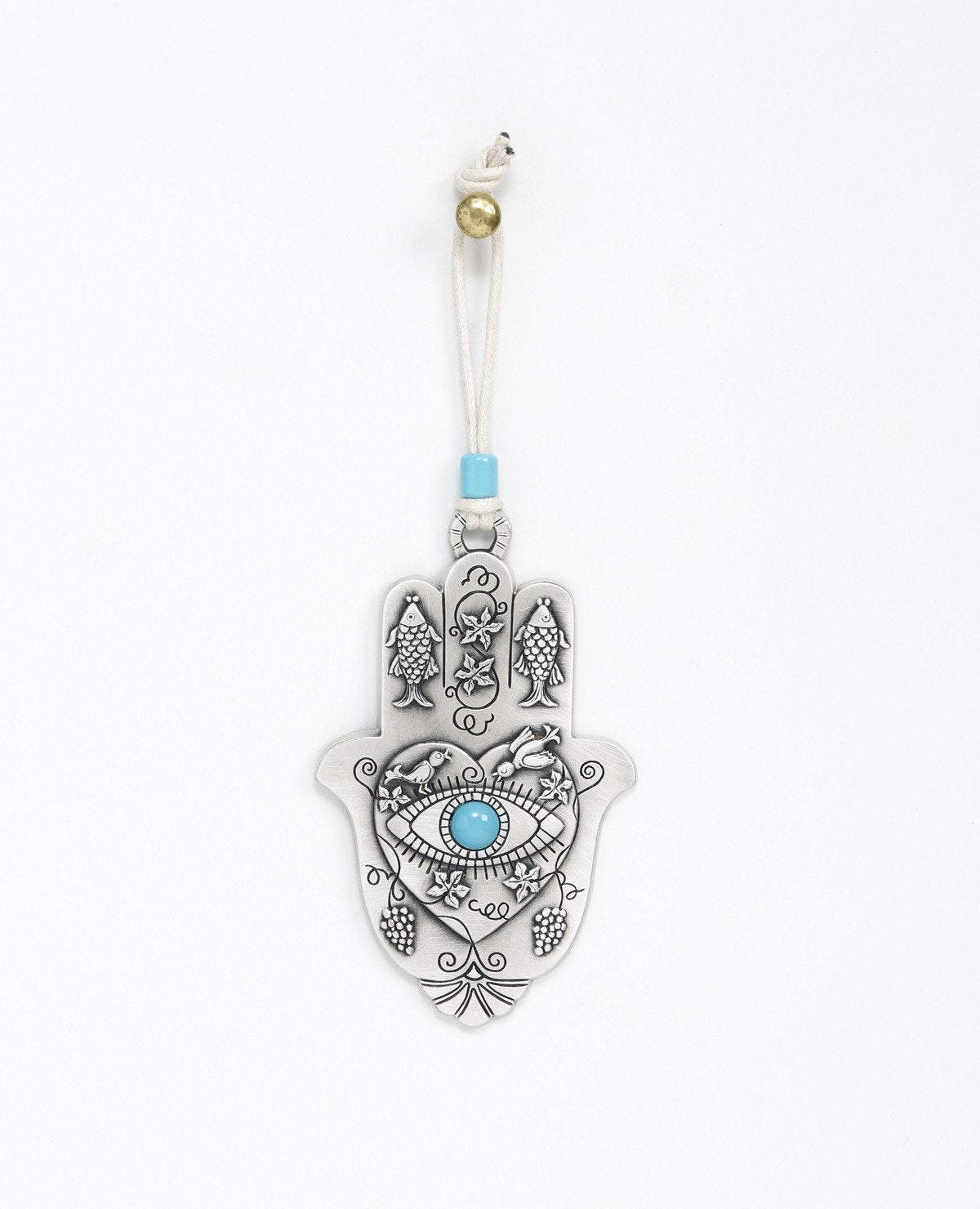 A hanging Hamsa ornament packed with goodness! The Hamsa is coated in sterling silver and comes with a natural colored faux leather string for hanging, decorated by a turquoise bead. At the center of the Hamsa is a big heart with an embossed eye inside embedded with a turquoise colored stone (against the "evil eye"). Above the eye are chirping birds (of peace and love). The Hamsa is decorated with embossed fish (for luck), as well as vine leaves and grape clusters (for abundance). What else could we ask for