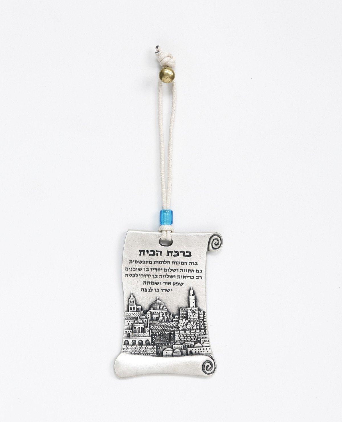A hanging Home Blessing ornament in the shape of a scroll, coated in sterling silver and decorated with a beautiful embossed image of the city of Jerusalem. The scroll shaped design connects us back to ancient times, which already then the power of words were acknowledged as a force that can manifest abundance and joy in our life. The hanging ornament comes with a faux leather string decorated with a blue colored bead. Length: 9 cm Width: 5 cm