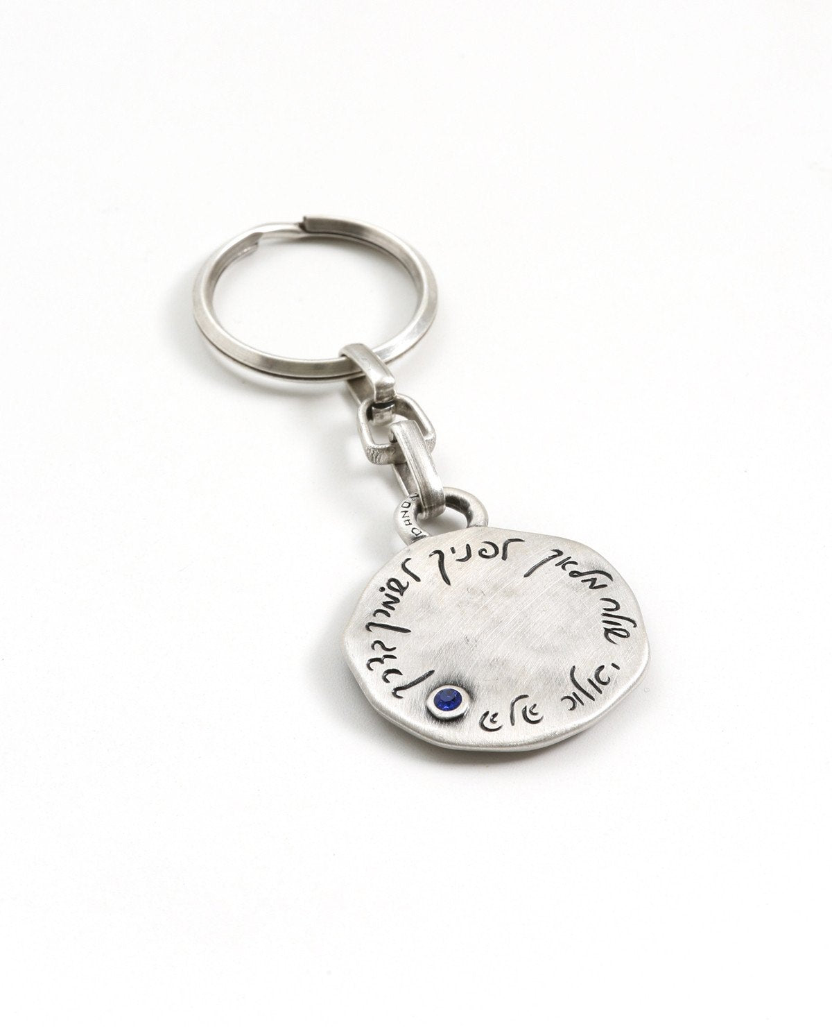 A "Shema Israel" keychain that feels good when in your pocket or bag. The keychain is designed as a circle with the words "Shema Israel" embossed on one side. Embedded on the other side is a blue colored Swarovski crystal with the engraved passage: "I am sending an angel ahead of you to guard you along the way". The keychain is coated in sterling silver and is strong and reliable. Makes a great present for anyone you wish to bless with a safe and successful journey through the deep connection to the words "