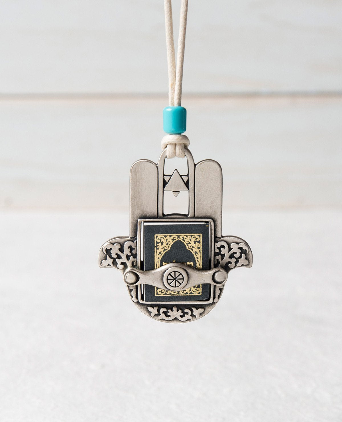 Sterling silver plated car pendant with a turquoise bead. Length: 7 cm Width: 6 cm