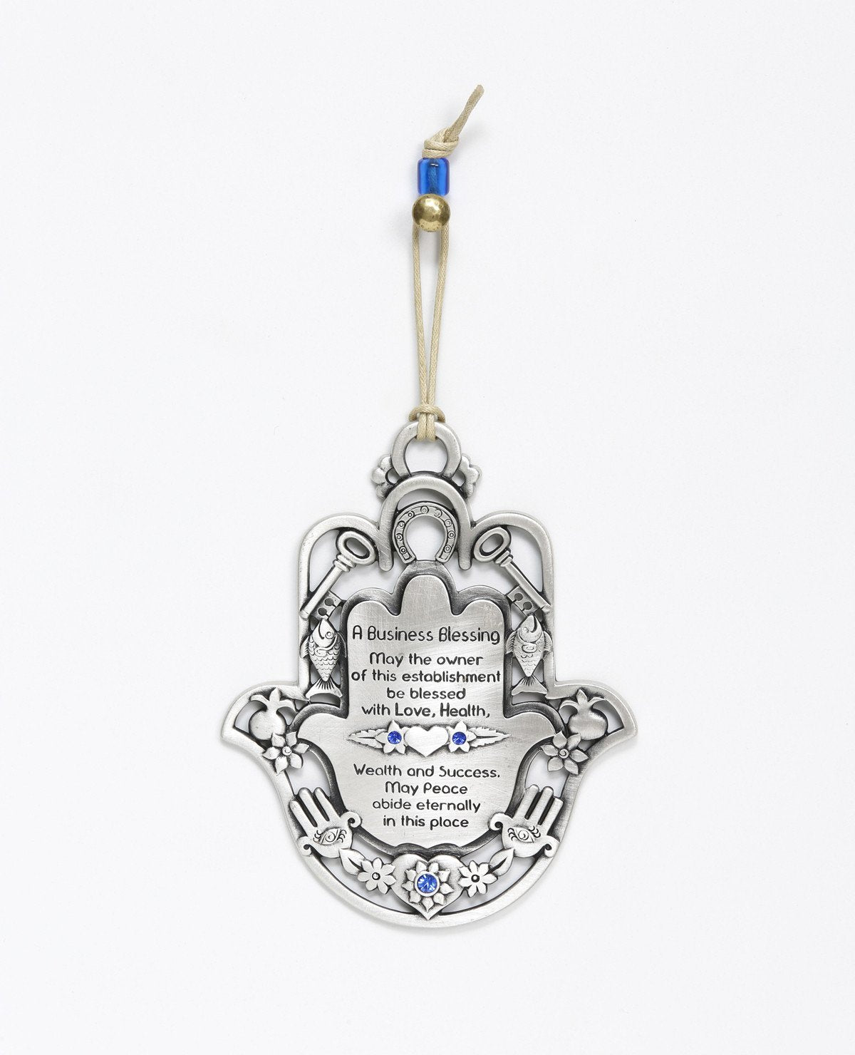 An impressive and richly designed Business Blessing Hamsa for hanging, coated in sterling silver and embedded with blue Swarovski crystals. The Hamsa comes as a frame and is decorated with motifs of luck, abundance and a blessing for the business with a plate at the center featuring blessings of wealth and livelihood. At the bottom of the plate is an engraved eye embedded with a blue crystal, to protect against the "evil eye". A wonderful and exciting gift for anyone with a new or existing business. The orn