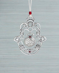 A hanging Hamsa ornament with a delicate filigree like design and a hollow pomegranate hanging at its center. The Hamsa is decorated at its edges with pairs of motifs from the world of good luck charms and blessings, among them a pomegranate, a flower, a fish and a key. All these face each other to multiply the strength of the blessings. Words that bestow prosperity, serenity, blessings, peace and success are written on the pomegranate which hangs from the center of the Hamsa. The ornament is coated in ster