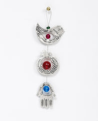 A graceful seven blessings hanging ornament coated in sterling silver, that brings joy and blesses. The ornament is made up from three motifs from the world of charms: a bird, a pomegranate and a Hamsa. All are connected to each other by a thin silver coated string decorated by colorful beads, with a loop at the end for hanging. Each motif is designed with unique decorative embossments, and together create a charming and harmonic whole. Written on each one of the shapes are words of blessing, in Hebrew on o