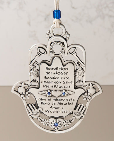 An impressive and exceptional hanging Home Blessing. Shaped like a Hamsa and decorated by motifs such as a key, a fish, a horseshoe and a pomegranate, which according to Judaism symbolize respectively: a new way, fertility, luck and abundance. The ornament is coated in sterling silver, embedded with blue Swarovski crystals, and comes with a faux leather string for hanging, decorated with a blue bead. A fantastic gift to grant any new home, great for new beginnings, or for anyone you wish to greet with love,