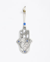 An aritistic, charming and delicately designed Hamsa hanging ornament. The Hamsa is coated in sterling silver and on its bottom part has a smooth plate with a big heart on it. Written inside the heart are seven blessings for: love, abundance, success, happiness, health, joy and luck. Surrounding the heart are flower decorations embedded with blue colored stones. On the top part of the Hamsa are three hollowed out fingers, with butterflies in between them. The ornament comes with a natural colored faux leath