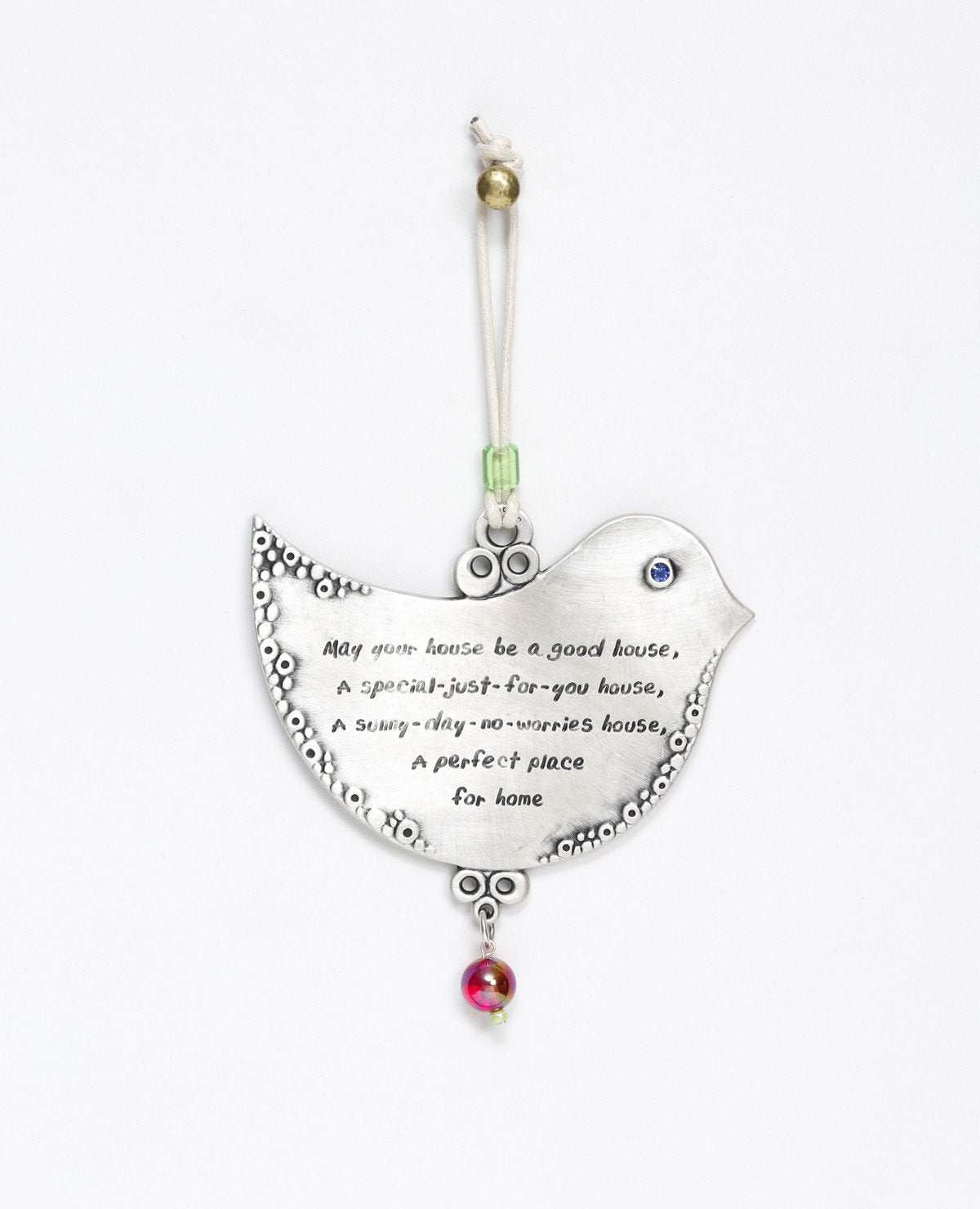 A hanging Home Blessing ornament shaped like a dove, with a special blessing for the home engraved on it in both Hebrew and English. The words are authentic and full of inspiration, calling for prosperity, love and wishes coming true. The ornament is coated in sterling silver, inlaid with a Swarovski crystal and comes with a faux leather string decorated with colorful beads. This original decorative piece makes an inspirational gift for the home, for new journeys and people that are loved. 
Comes also in yo