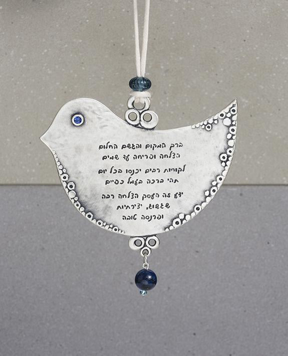 A dove shaped wall ornament with a business blessing in both English and Hebrew. The charming hanger is coated in sterling silver and decorated around the edges with a delicate artistic engravement and embedded with blue Swarovski crystals and blue decorative beads. The exciting blessing words for business success are written in Hebrew on one side and English on the other. Makes the perfect gift to warm up any new or existing place of business, in Israel or abroad, as a heartfelt gesture and a souvenir from