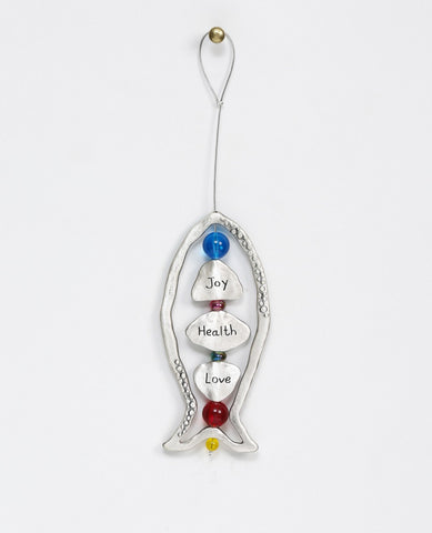 Happiness, health, love! What else could we ask for? A large sterling silver coated hanging ornament in the shape of a fish, with a beautiful design that focuses on generosity. The frame of the fish is hollow and decorated by pretty embossments on its sides. At the center of the fish, upon a thin silver rod, blessing charms are thread with colorful beads in between them. The words "happiness", "health" and "love" are engraved on the charms in Hebrew on one side and in English on the other. The silver rod co
