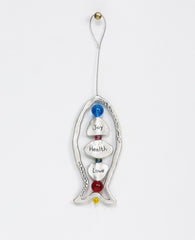 Happiness, health, love! What else could we ask for? A large sterling silver coated hanging ornament in the shape of a fish, with a beautiful design that focuses on generosity. The frame of the fish is hollow and decorated by pretty embossments on its sides. At the center of the fish, upon a thin silver rod, blessing charms are thread with colorful beads in between them. The words "happiness", "health" and "love" are engraved on the charms in Hebrew on one side and in English on the other. The silver rod co