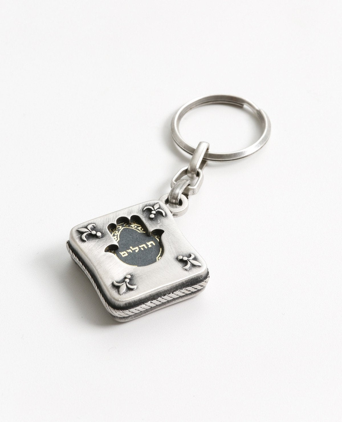Tehillim is always with you. An exciting and elegantly designed keychain coated in sterling silver. Fashioned in the form of a small silver envelope with the book of Tehillim inside. The outline is designed on both sides as a frame with a hollow Hamsa shape in the middle, through which we can see the book on both its front and back sides. Feel safe and connected to your roots any time you have this wonderful keychain on you. You will feel even better when you grant it with love to the dearest people in your