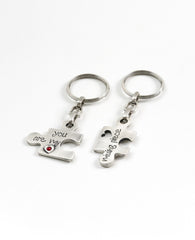 A pair of originally designed keychains, surprising and exciting, coated in sterling silver. The keychains are designed as two pieces of a puzzle that complete each other. On each keychain part of a love sentence is inscribed, with the completing bit on the other piece. The keychains are embedded with colorful Swarovski crystals. Will you find your missing piece of the puzzle? Or grant it as a gift of love to your favorite couple? We warmly recommend either!  Length: 6 cm  Width: 4 cm