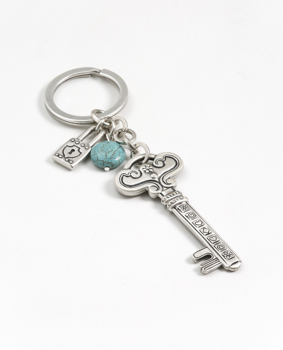 This keychain opens the door to success! A double sided key, which on one side has the words "your key to success" inscribed, and the other side is decorated with rich motifs and noble embossments. The tip of the key is attached to a linked chain which has a small lock and a beautiful turquoise stone hanging from it. The keychain is coated in sterling silver and is strong and reliable. A gift for those with a taste for the finer things, which you wish to remind that any lock in their life can be opened by t