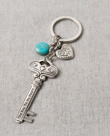 Love is the key to everything! Always! A keychain that is all love. Designed as a large and impressive key decorated with embossed artistic elements and tiny hearts. On one side the sentence "Love Is The Key" is engraved, and on the other side the sentence "The Key To My Heart". Connected to the top of the key is a chain with a sweet heart and a beautiful turquoise stone hanging upon it. The keychain is coated in sterling silver and is strong and reliable. An exciting gift for those still searching for the 