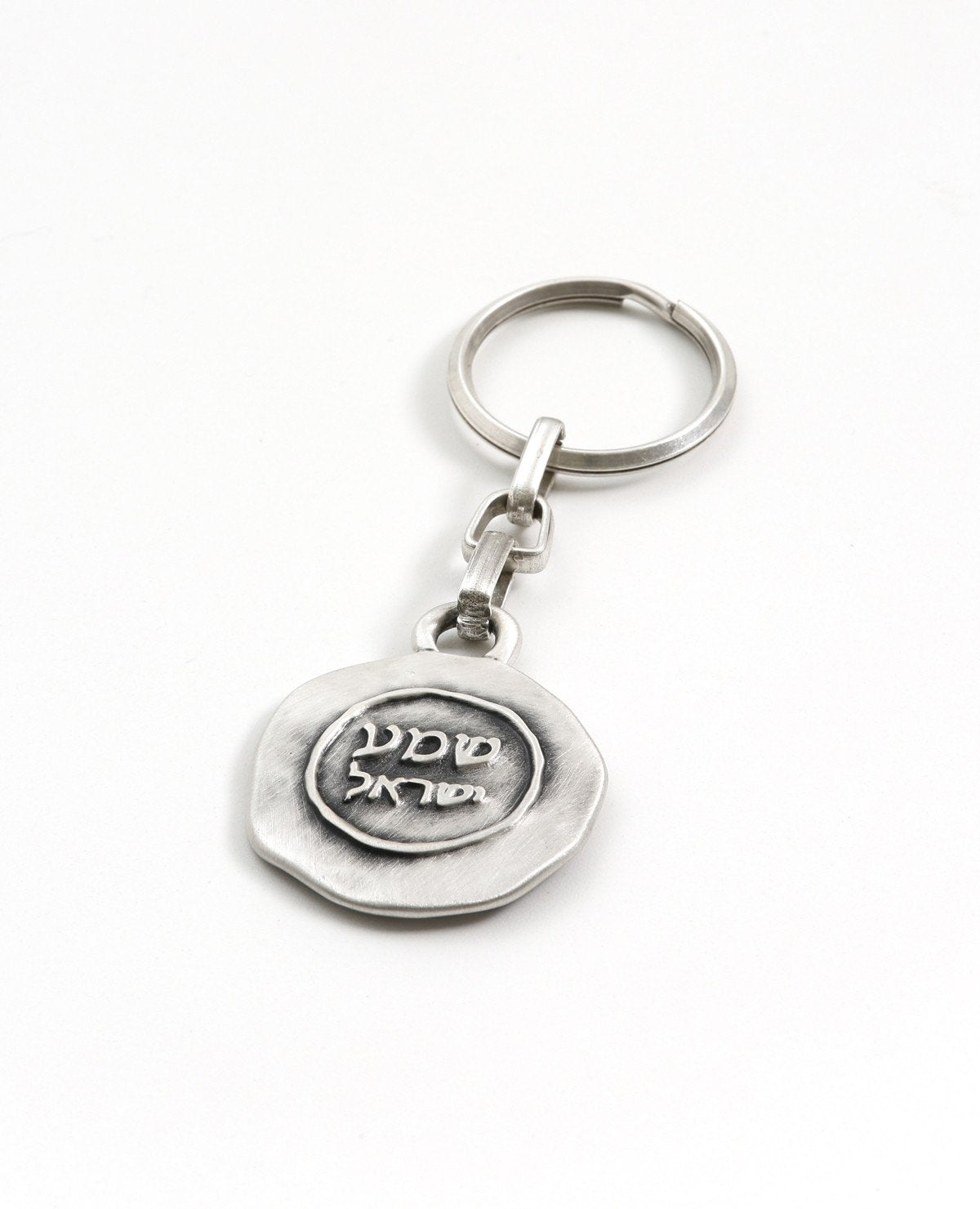 A "Shema Israel" keychain that feels good when in your pocket or bag. The keychain is designed as a circle with the words "Shema Israel" embossed on one side. Embedded on the other side is a blue colored Swarovski crystal with the engraved passage: "I am sending an angel ahead of you to guard you along the way". The keychain is coated in sterling silver and is strong and reliable. Makes a great present for anyone you wish to bless with a safe and successful journey through the deep connection to the words "