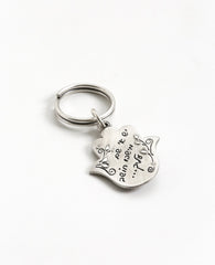 Someone is thinking good thoughts about you... A beautiful and unique Hamsa shaped keychain that will simply warm any heart. Engraved on one side of the Hamsa, between floral decorations, is the sentence "Someone is thinking of you". The other side is embedded with a round blue colored stone and is engraved with the words: "Love, Health, Happiness". We read your mind and designed this perfect gift especially for you, allowing you to pass on your loving thoughts in the most original way. The keychain is coat