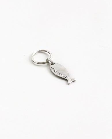 Sometimes we swim against the current to maintain integrity to our own personal statement. This fish shaped keychain is coated in sterling silver and has the words "swimming against the current" engraved onto it. The most suitable gift for when you want to remind someone close that it is allowed and even recommended to always be true to yourself and your inner voice. This keychain is motivating, strong and reliable.  Length: 6 cm  Width: 1 cm