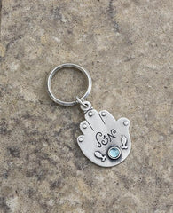 Sterling silver plated key ring with a Swarovsky crystal.  Length: 8 cm  Width: 4 cm