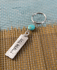 A classically designed keychain - for him or for her. Shaped like an elongated rectangle with the words "Everything is Possible!". Written on the other side are empowering words of hope and inspiration. A rounded turquoise bead at the top of the keychain completes the classic look. The keychain is coated in sterling silver and is strong and reliable. A gift that is always appropriate to give to a special person, in any opportunity, to remind that when you want something and believe - everything is possible!