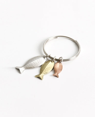 A stunning keychain that comes with a smile and a triple blessing. Designed in the shape of a ring upon which hang three cute fish in different sizes, coated in three different metals and colors: silver, gold and copper. The fish symbolizes fertility, abundance and luck (in Hebrew fish spelled backwards is luck). A fun gift full of beauty, motion and lots of good luck! Grant it with love to anyone important which you hold dear, and to anyone who you always wish luck, abundance and blessing. The keychain is 