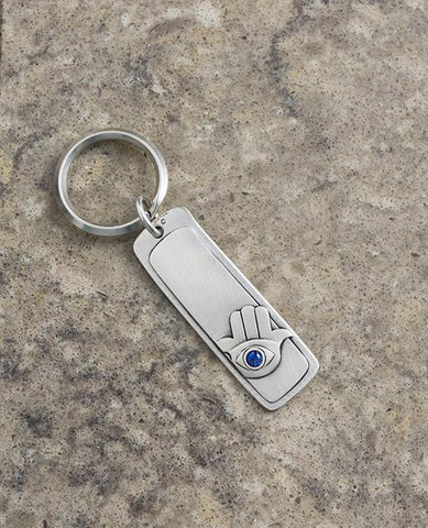 An exceptional keychain that connects us straight to our origins, the blessing of Jacob to Joseph. 
The keychain is designed as a rectangle with the words "Ben Porat Yosef" written on one side, and on the other side is an embossed Hamsa embedded with a blue Swarovski crystal.
The keychain is coated in sterling silver and is strong and reliable.
Very suitable as a gift for those who connect to the unique qualities of the ancient expression "Ben Porat Yosef", as a blessing and talisman for protection from any