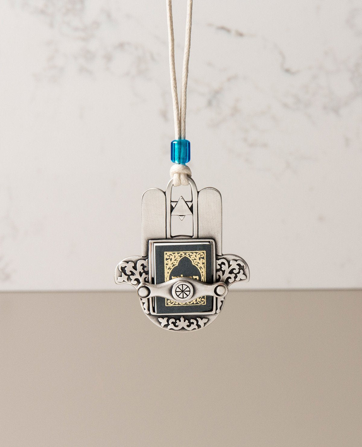 Sterling silver plated car pendant with a blue bead.  Length: 7 cm  Width: 6 cm