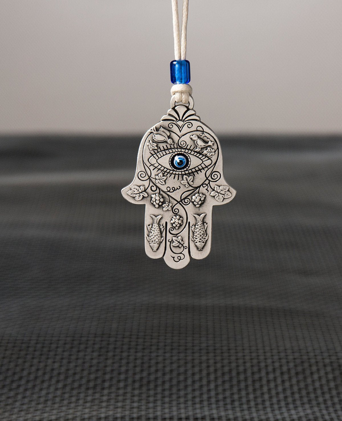 Sterling silver plated car pendant with a blue bead.  Length: 7 cm  Width: 4 cm